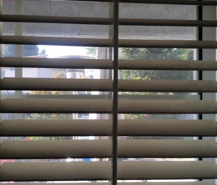 Soot on blinds after a fire.
